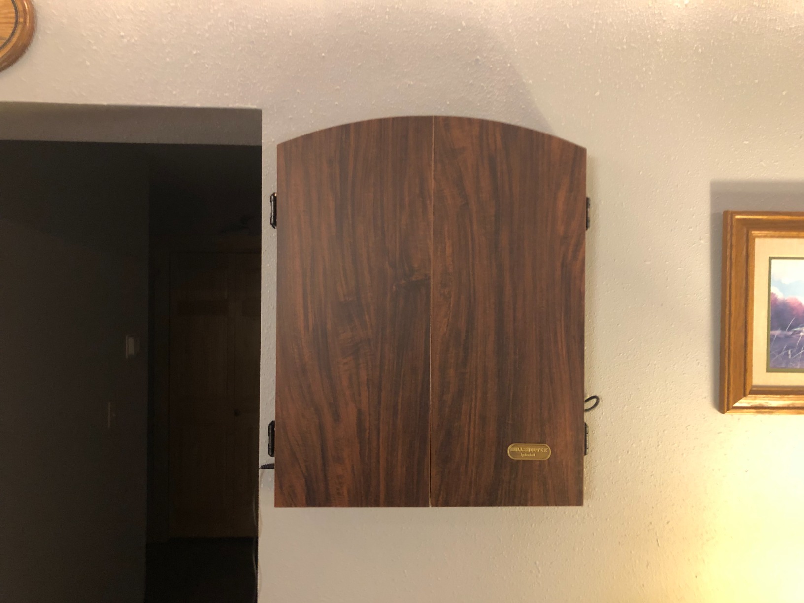 Arachnid CricketMaxx 1.0: 13.5” recreation size with wood cabinet. Features 34 games, 183 variations, 8-player LED X/O scoring, and Heckler mode. Integrated storage for darts and accessories customer photo 1